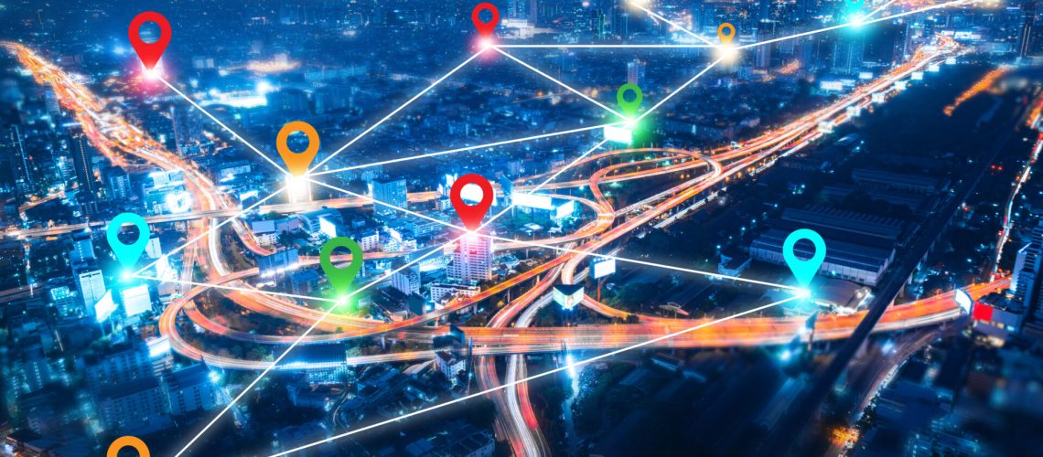 colorful pin landmark location on aerial view of modern downtown skyline and highway transportation in modern city with location link network connection for meter verse trend worldwide link technology